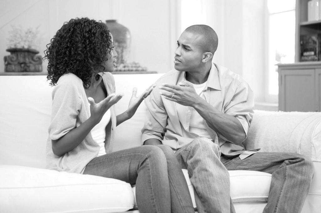 unhappy-couple-arguing-on-the-couch-picture-id843702630